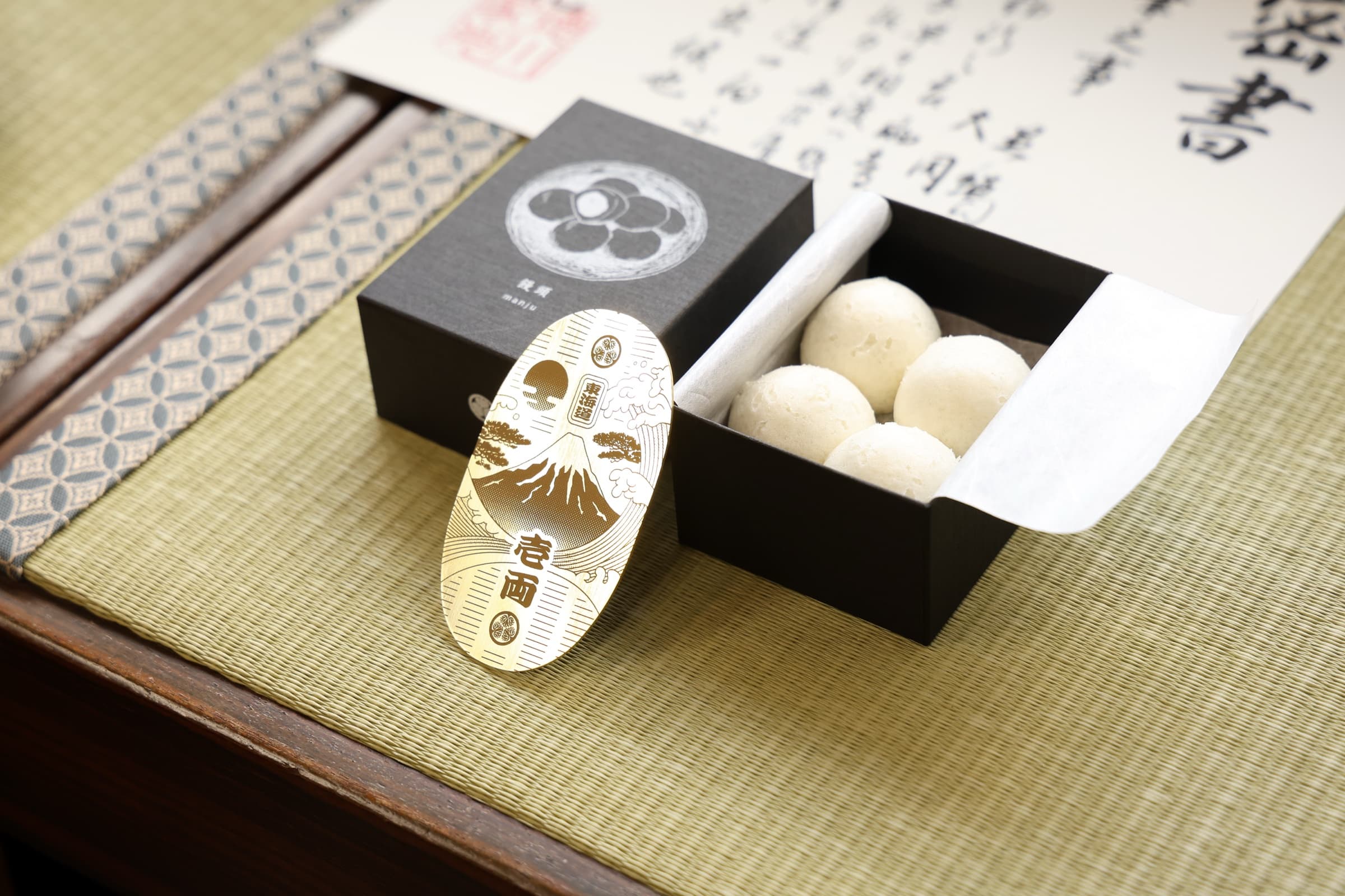 One gold ryō and a sealed letter — the sweet-shop knows what it is worth